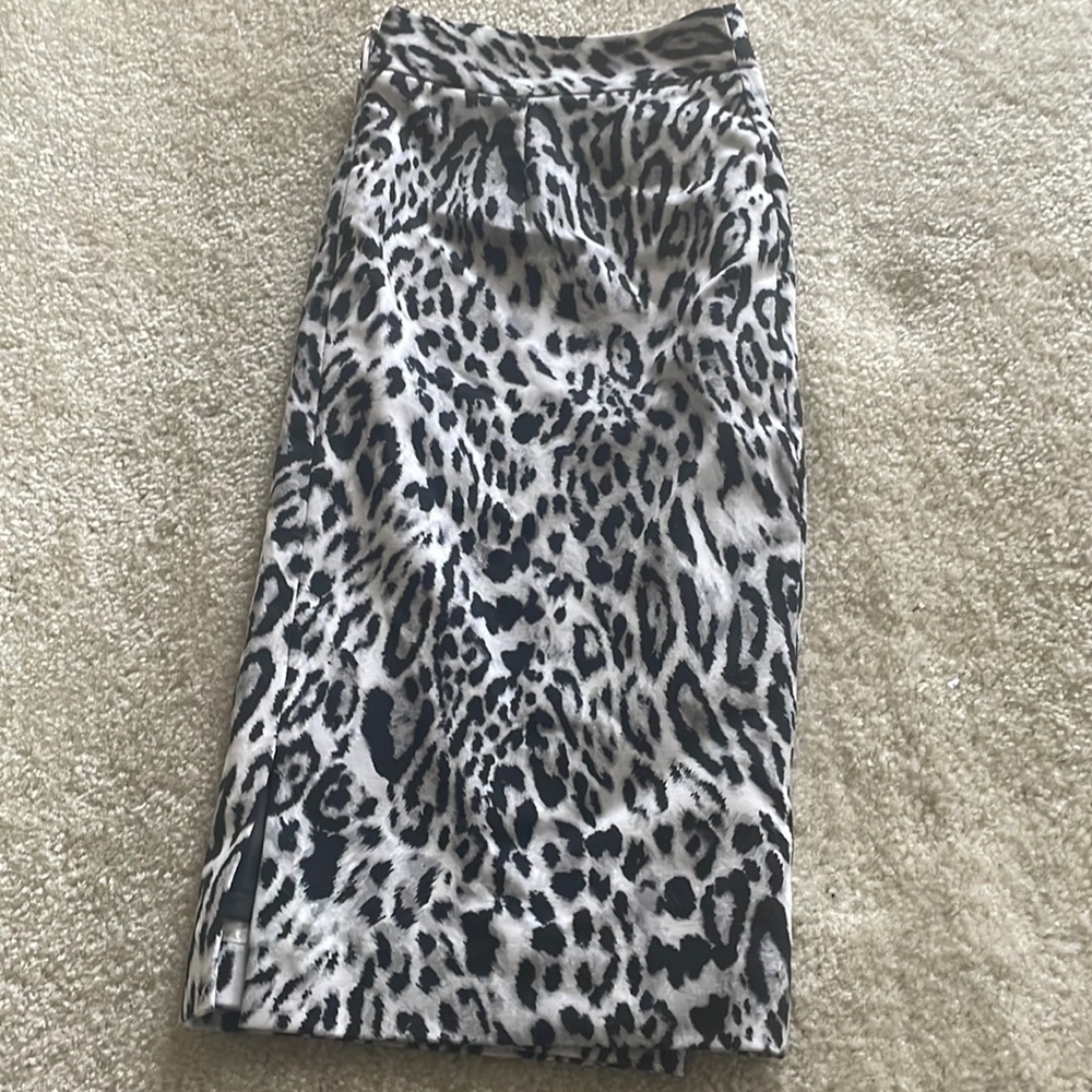 Woman’s black and white animal print pencil skirt just above knee length .